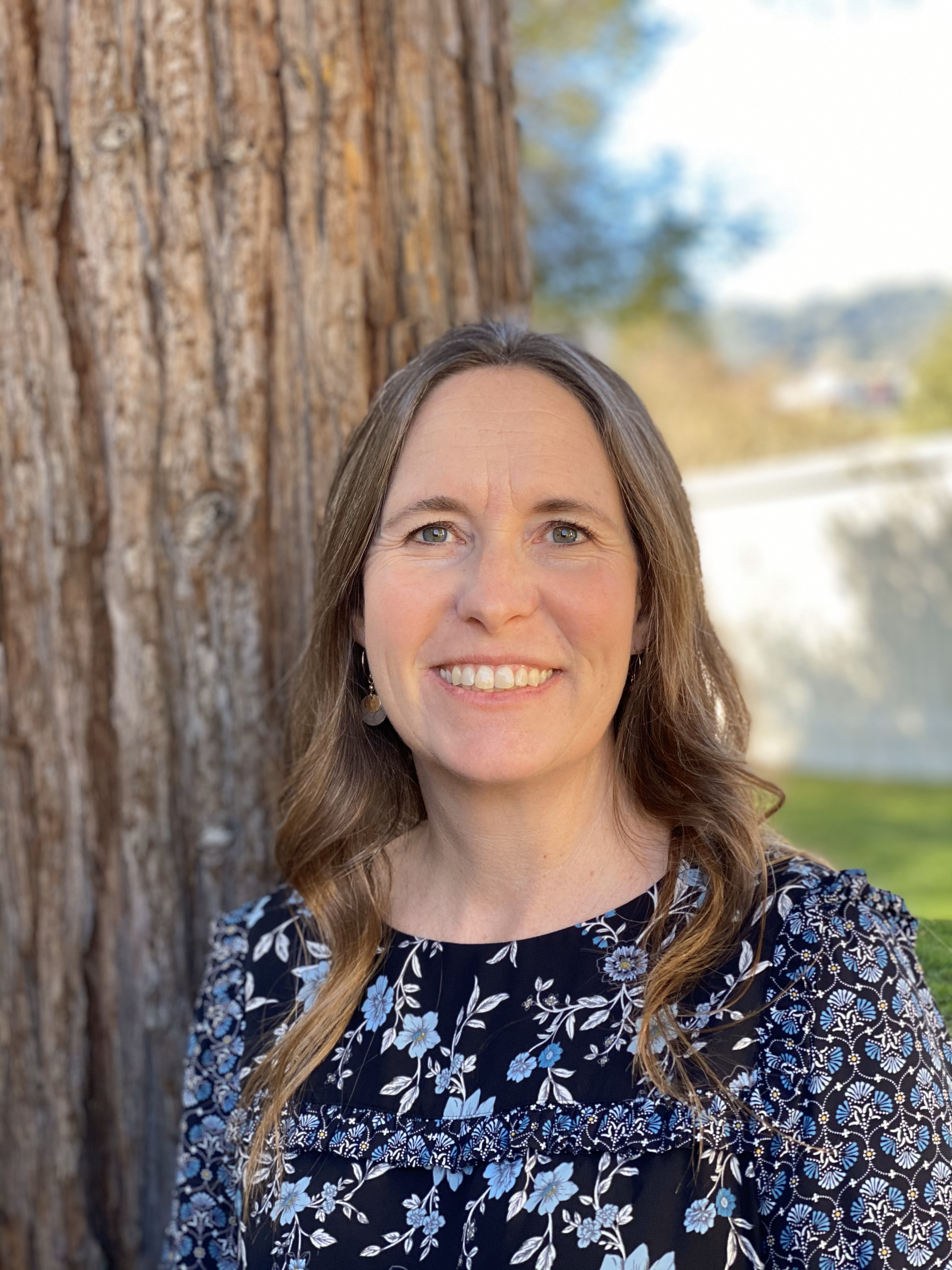 photo of cynthia leaning on tree