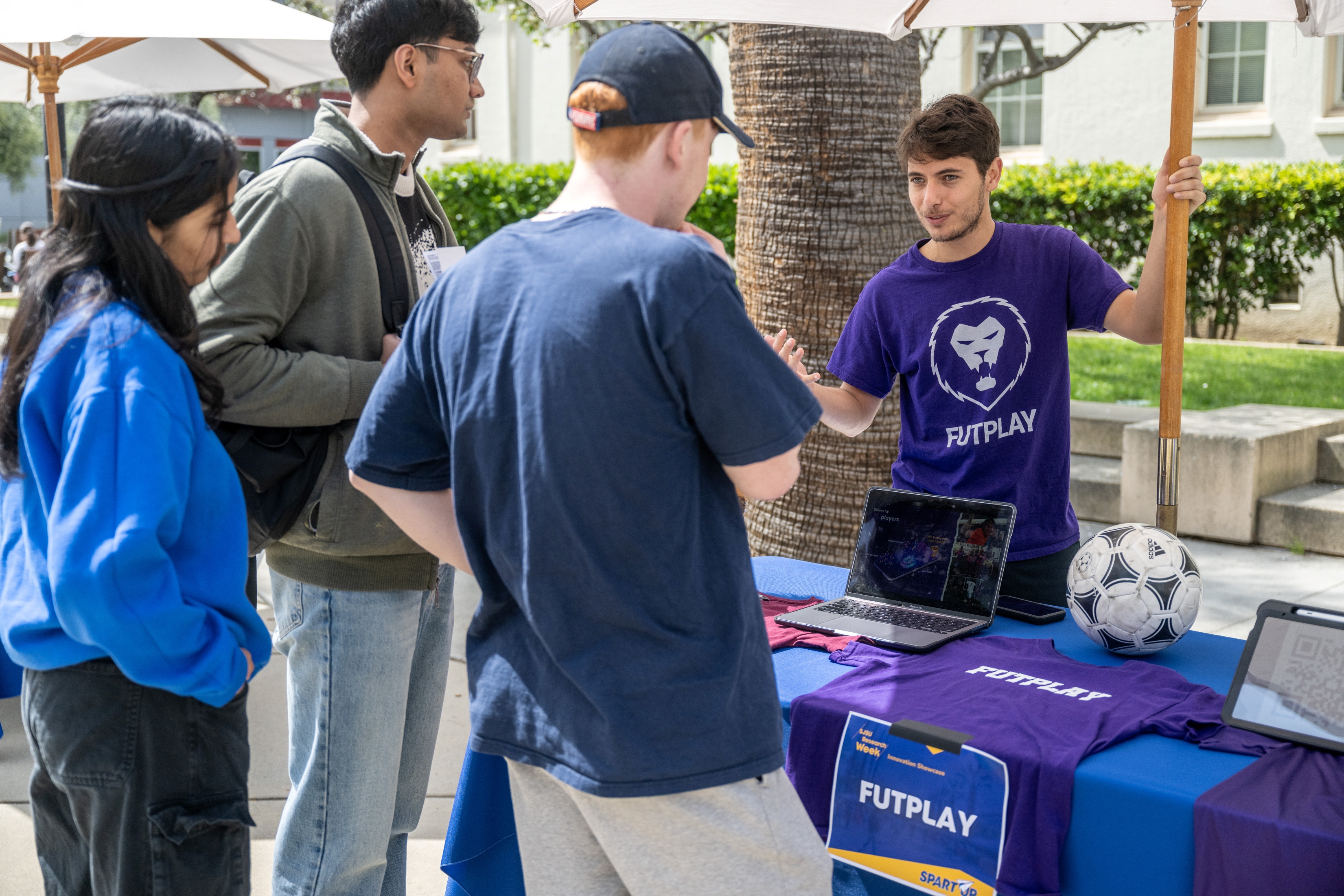 Student talking to other students about his startup